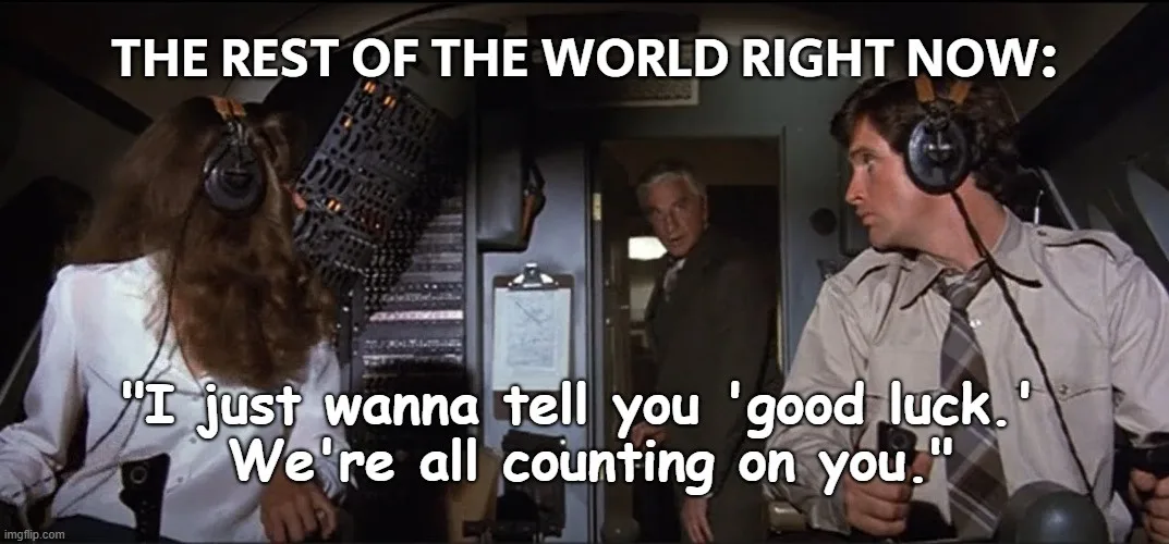 A still from the movie 'Airplane!' shows two flight attendants in a cockpit, one speaking to the other. The text overlay…
