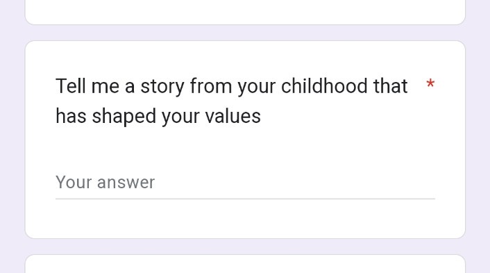 A screenshot of a text input field on a mobile app or website, displaying the prompt 'Tell me a story from your childhood…