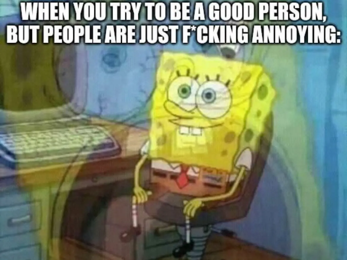 The image shows the animated character SpongeBob SquarePants sitting in an office chair at a desk with a computer, wearing a…