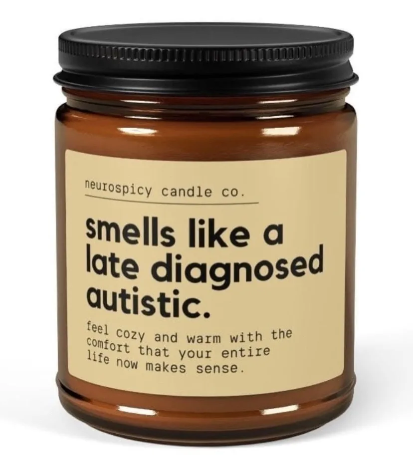 A brown glass candle jar with a black lid and a beige label from 'neurospicy candle co.' The label reads 'smells like a late…