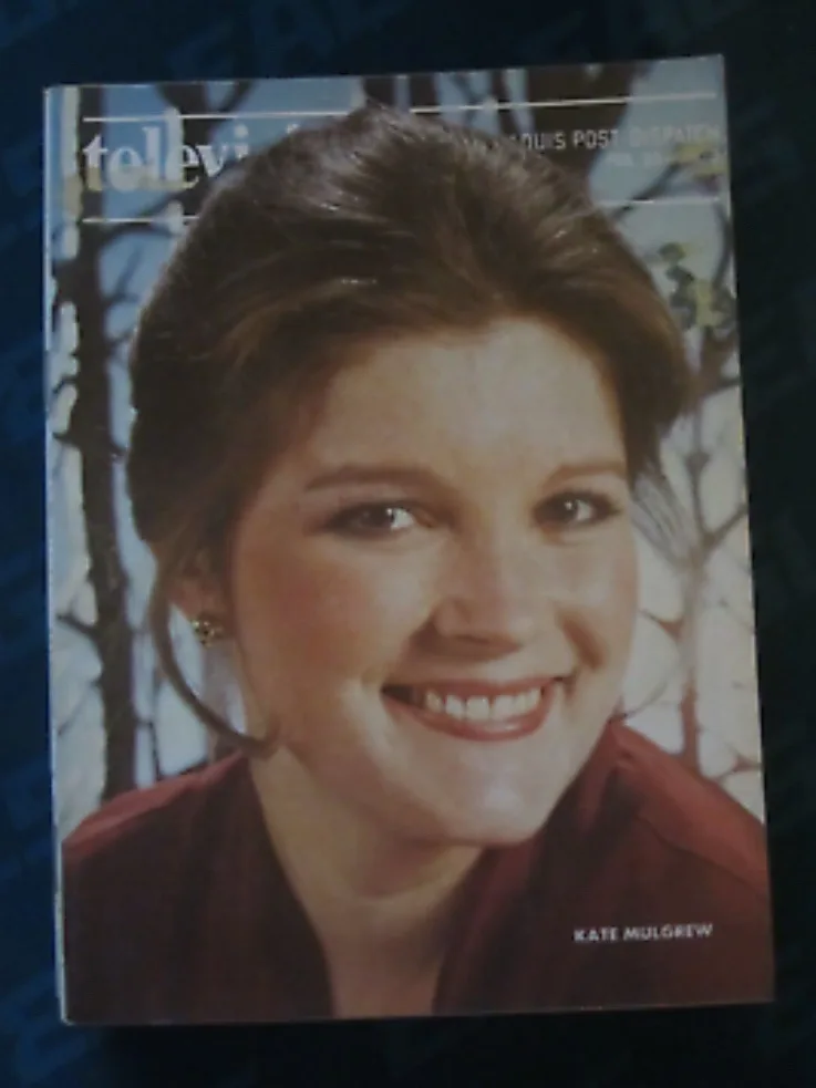 A vintage magazine cover featuring actress Kate Mulgrew smiling warmly, wearing a red top and small earrings, with the…