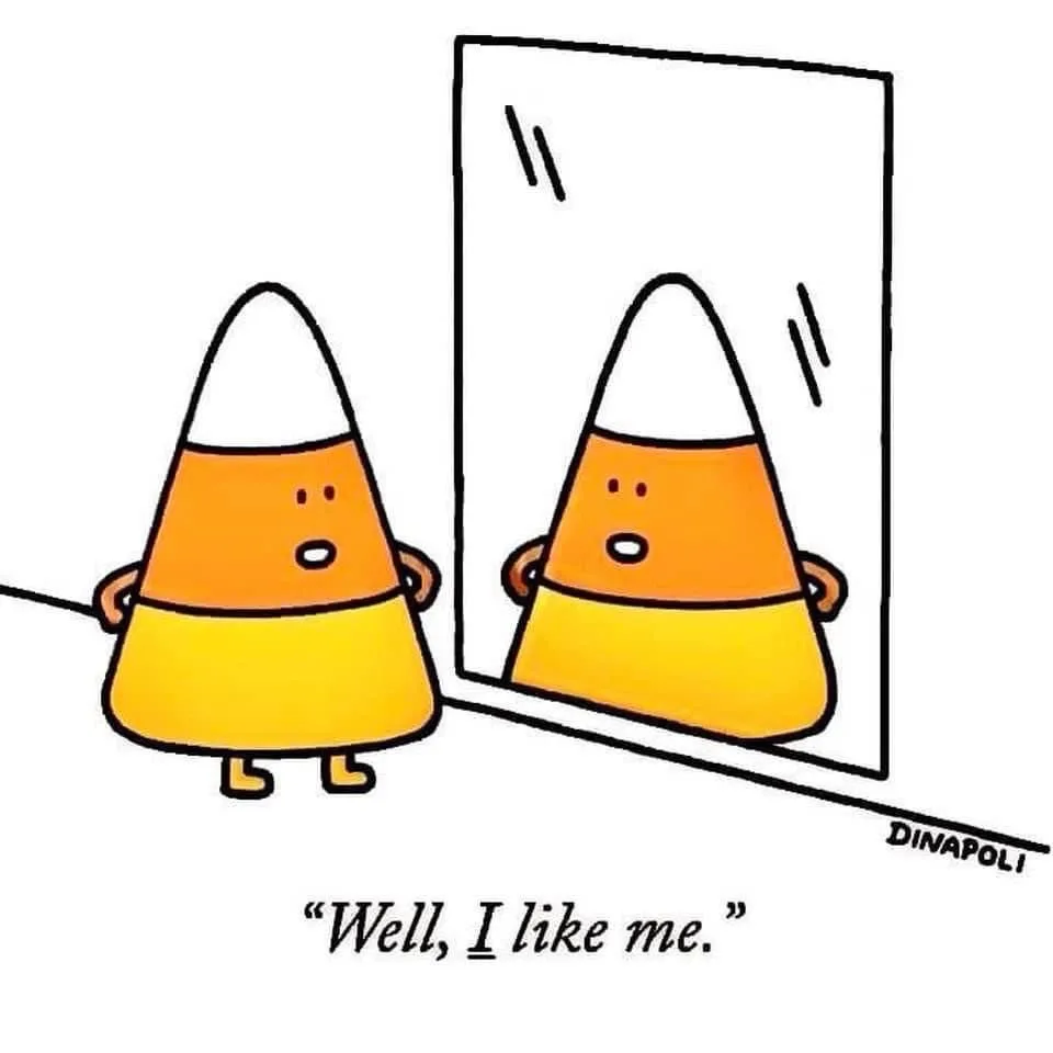 A cartoon candy corn character with a surprised expression stands before a mirror, looking at its own reflection which has…