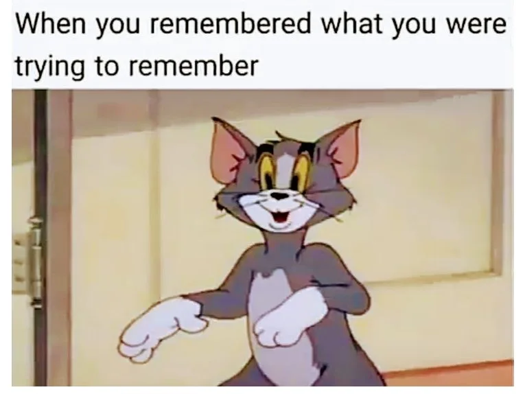 A cartoon cat, Tom from 'Tom and Jerry', stands in a doorway with a triumphant, wide-eyed grin, arms slightly outstretched…