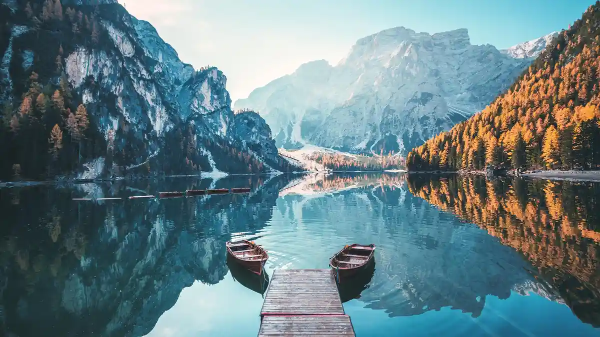 Row a boat on serene waters, surrounded by breathtaking alpine vistas in all directions. Lago di Braies, also known as…