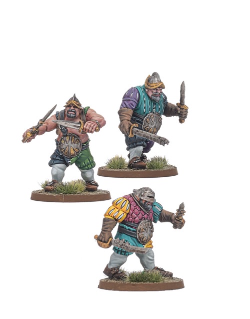 Three painted miniature figurines of dwarves, each holding a sword and shield, posed in combat stances on separate grassy…