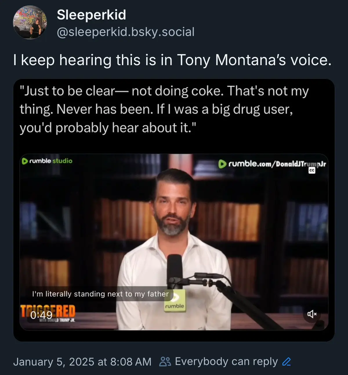 A screenshot of a social media post showing a video clip of Donald Trump Jr. speaking into a microphone. The overlaid text…