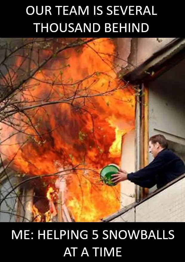A man stands on a balcony holding a green bucket, looking out at a large fire engulfing a building. The text at the top…