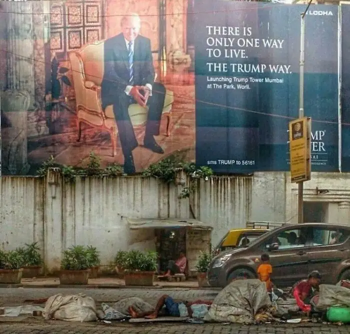 A large billboard advertising Trump Tower Mumbai features a photo of Donald Trump seated in a chair with the text 'THERE IS…