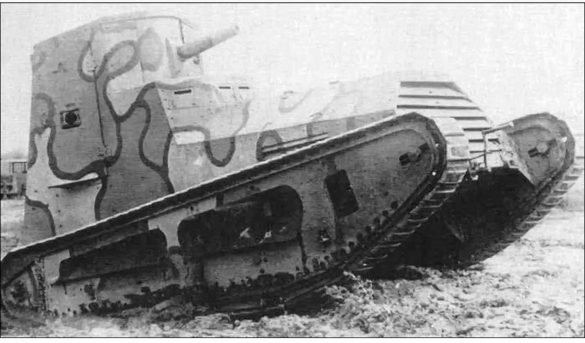 a black and white historical photograph shows an early tank, possibly a french char 2c, stuck sideways in muddy terrain. the…