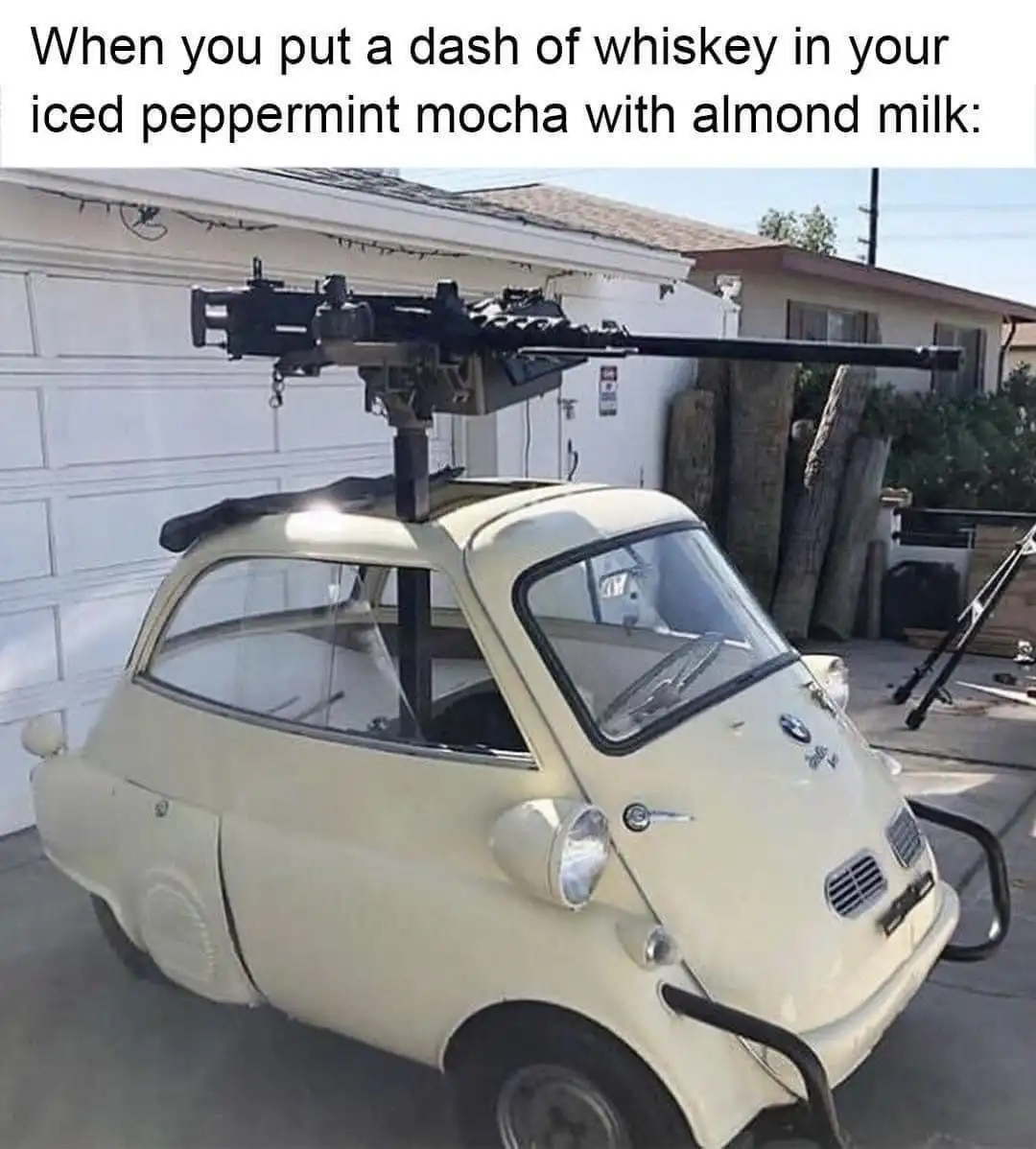 A beige BMW Isetta car parked in a driveway has a large machine gun mounted on a pole above its roof. The overlaid text…