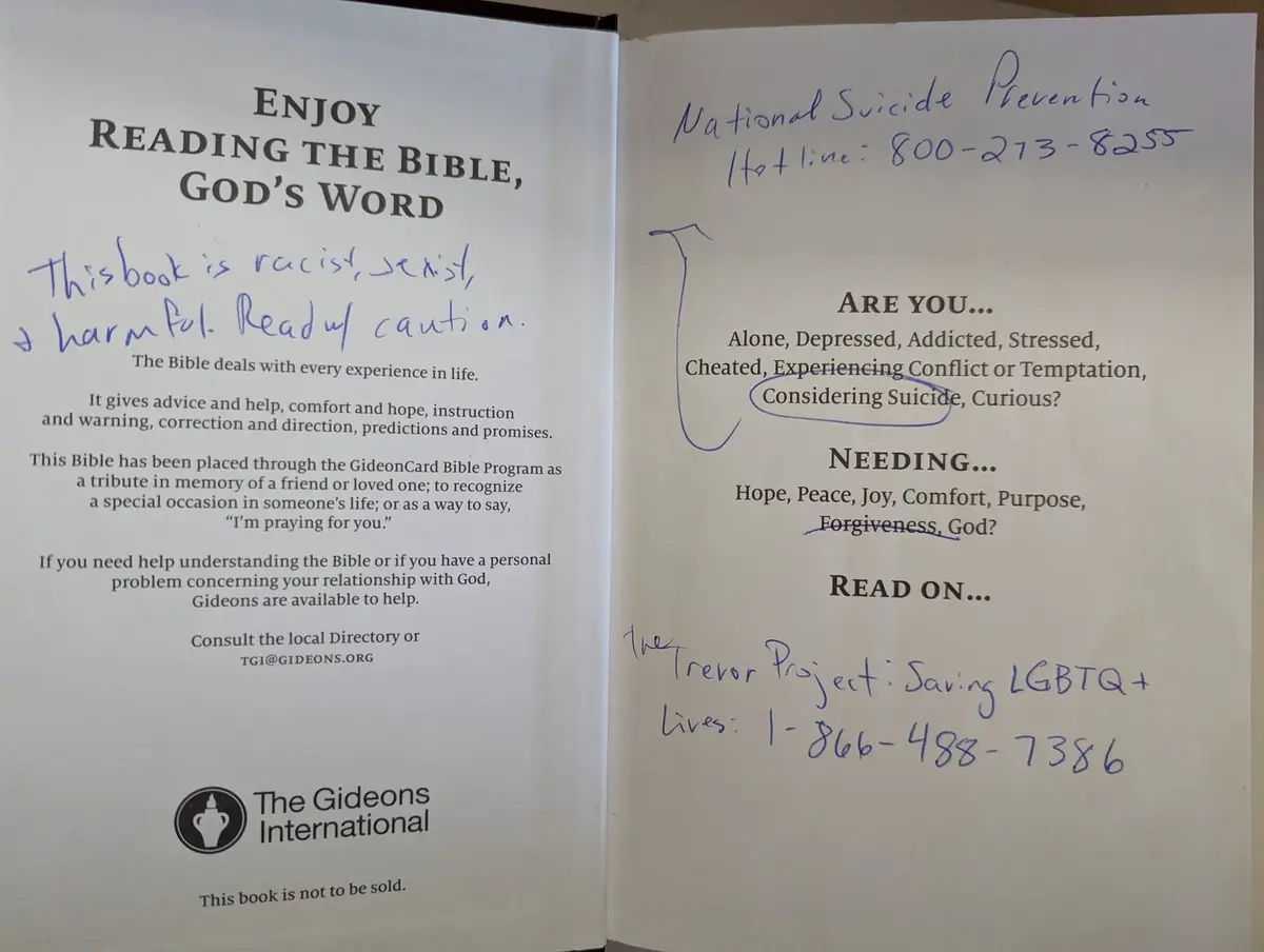 An open Bible with handwritten notes. The left page has a note saying 'This book is racist, sexist, and harmful. Read with…
