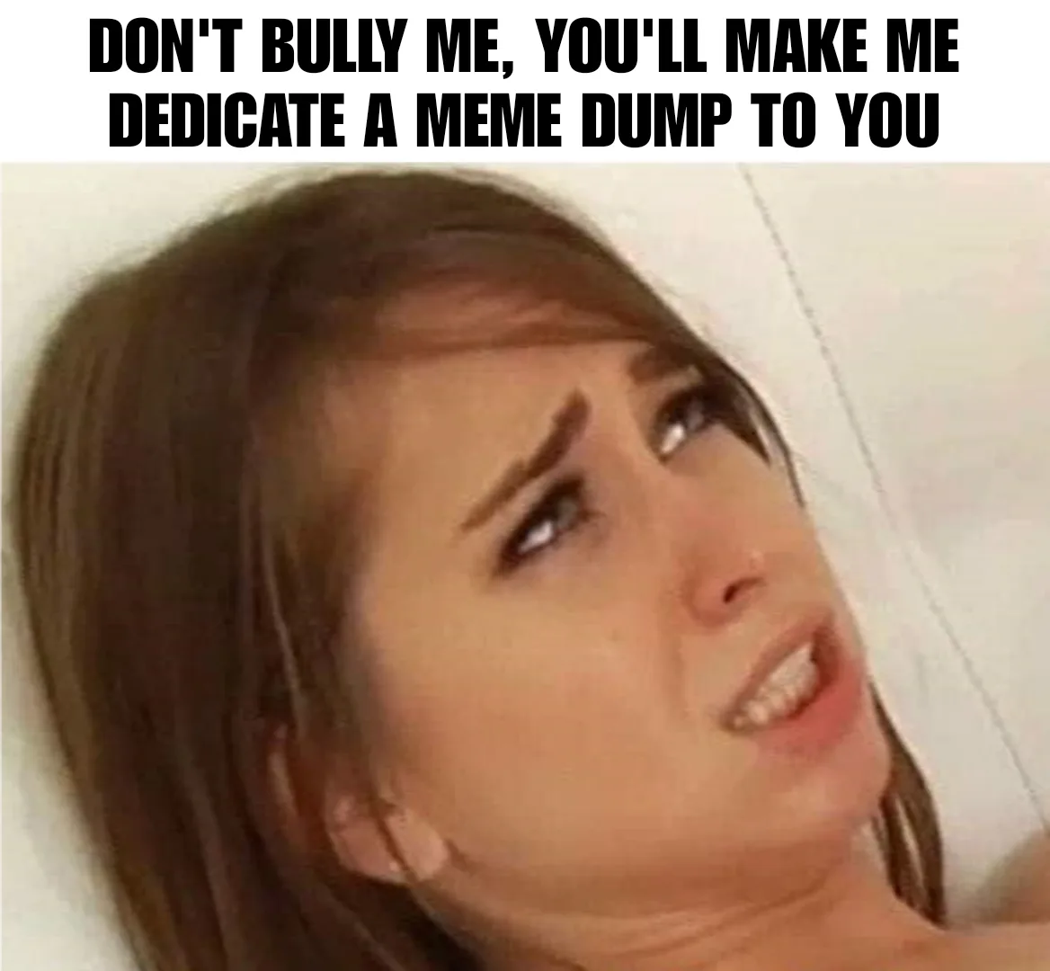 A close-up image of a woman with brown hair, looking upward and to the side with a defiant, slightly menacing expression…
