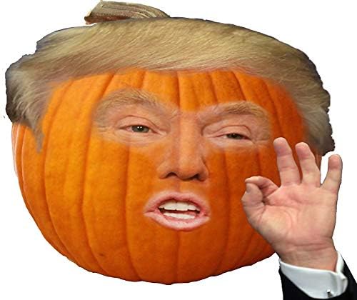 A carved orange pumpkin has a digitally superimposed image of Donald Trump's face and his signature comb-over hairstyle. His…