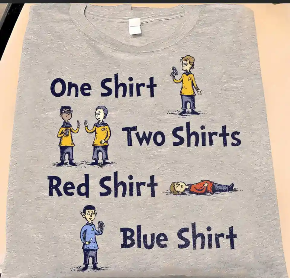 A gray t-shirt displays four cartoon illustrations of Star Trek crew members with text labels. Top left shows two officers…