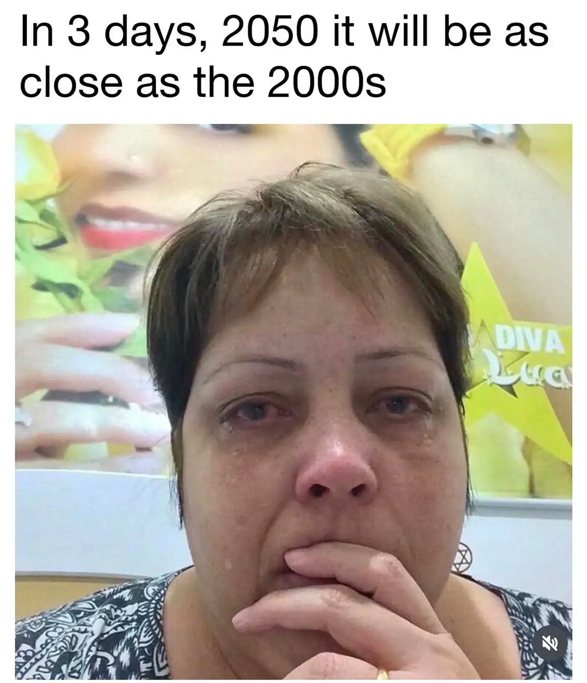 A woman with short brown hair, visibly distressed with tears and her hand covering her mouth, stares directly at the camera…