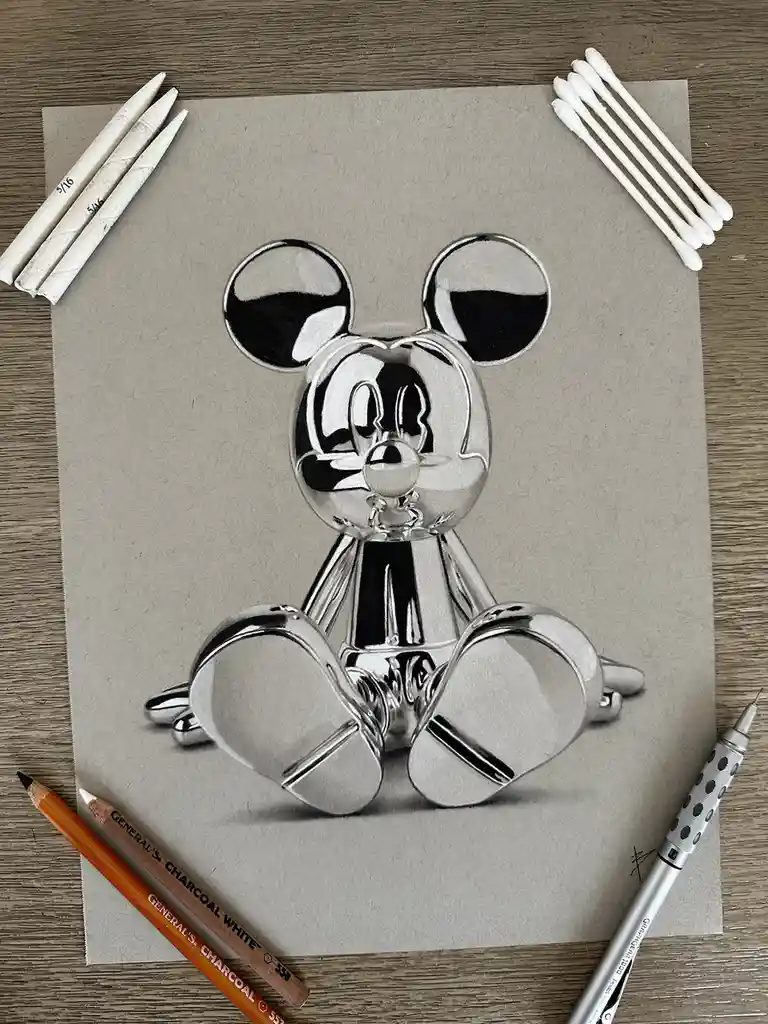 A hyperrealistic charcoal drawing of Mickey Mouse rendered to look like a shiny chrome statue sits on textured paper…