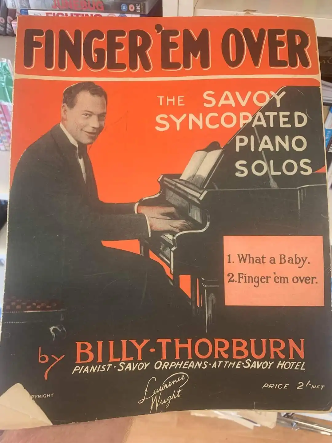 A vintage sheet music cover for 'Finger 'em Over' by Billy Thorburn, featuring a smiling man in a suit playing a piano…