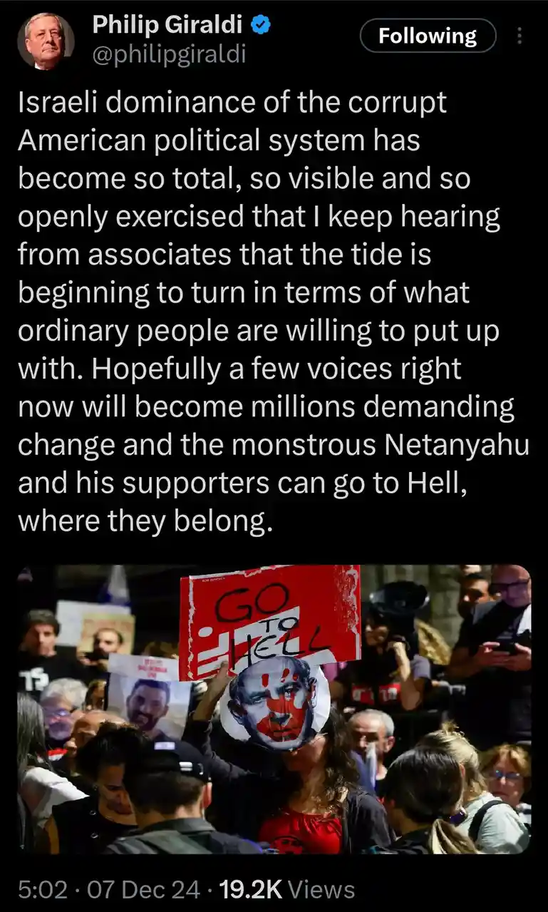 A screenshot of a tweet by Philip Giraldi showing a protest image where a person holds a red sign with 'GO TO HELL' written…