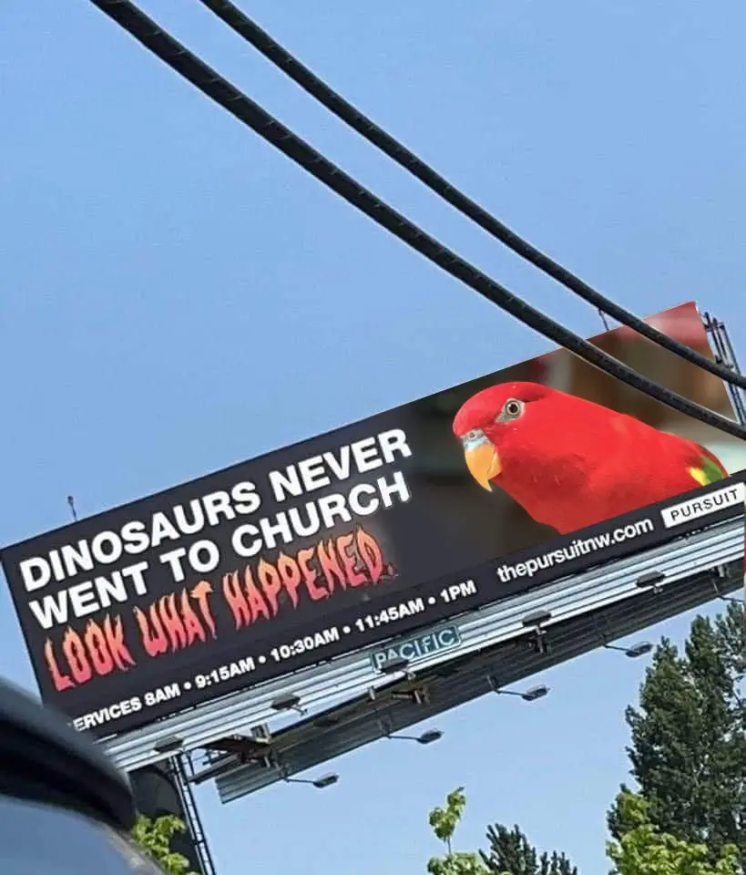 A billboard for 'The Pursuit' church features a large image of a red parrot on the right side, with the text 'DINOSAURS…