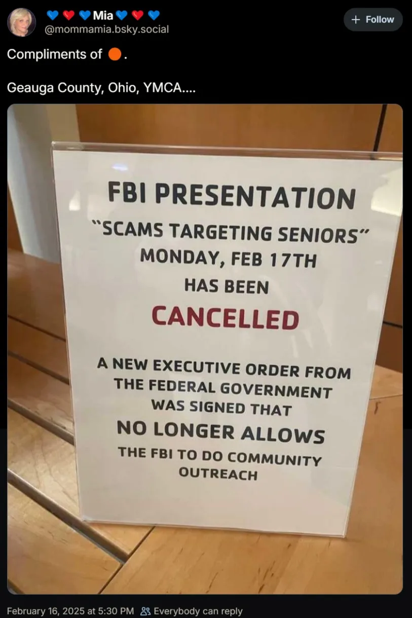 A white sign in a clear plastic holder on a wooden table announces the cancellation of an 'FBI Presentation: Scams Targeting…