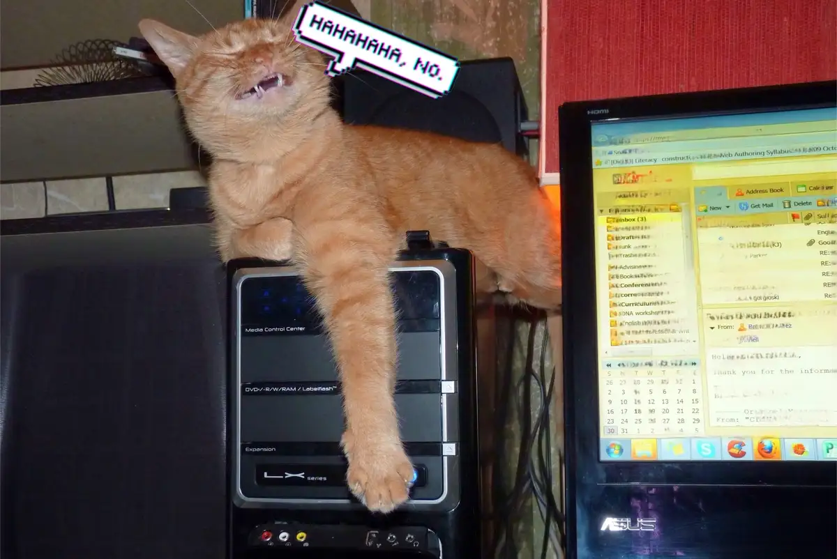 An orange tabby cat is lounging atop a black computer tower, its head tilted back with mouth open showing teeth, as if…