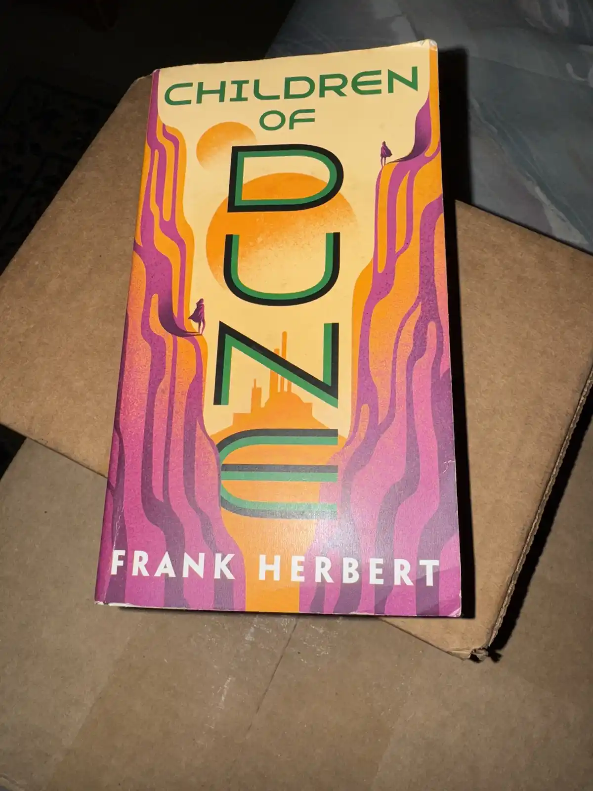 A book cover for Frank Herbert's 'Children of Dune' is shown, featuring large green letters spelling 'DUNE' with stylized…