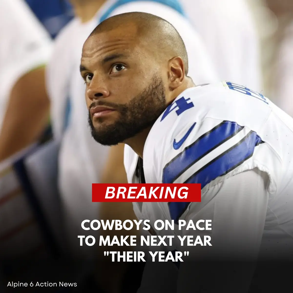 A close-up photo of a balding, bearded football player in a white Dallas Cowboys jersey with blue stripes and a Nike logo…