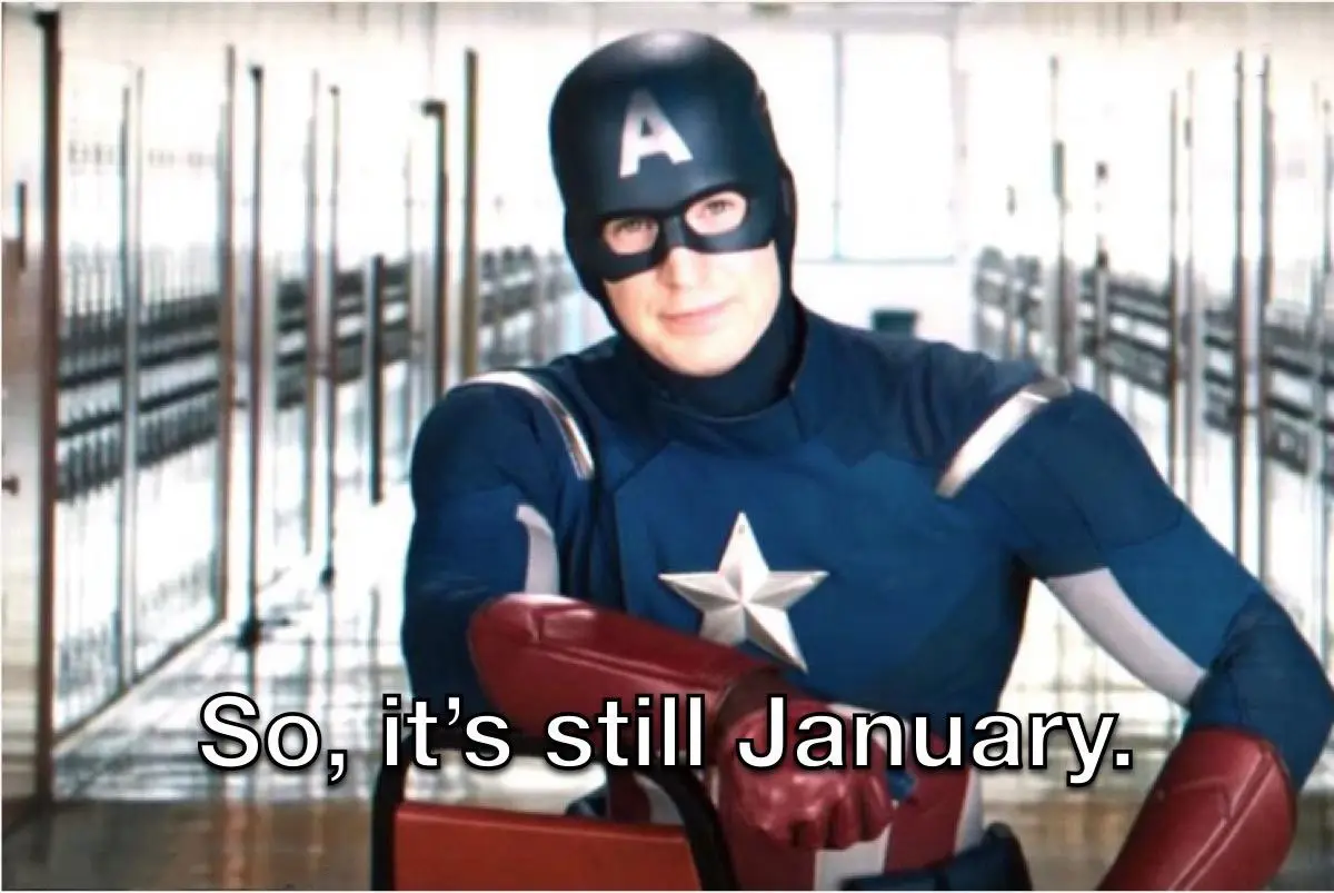 A man in a Captain America costume, featuring a blue suit with a white star, red gloves, and a helmet with an 'A', is seated…