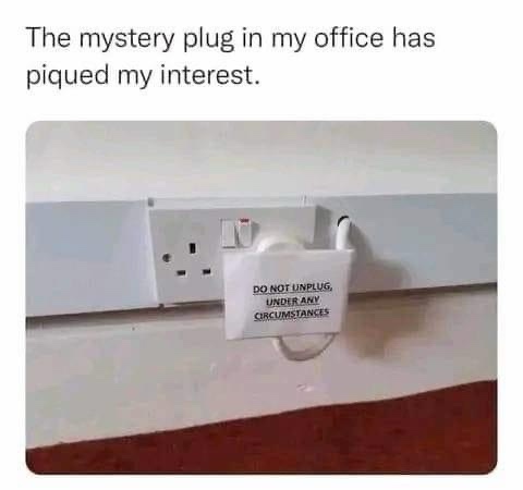 A white electrical outlet with a white plug inserted into it, secured by a white plastic box labeled 'DO NOT UNPLUG, UNDER…