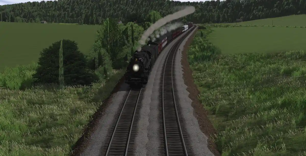 A steam locomotive pulls a train through a green, rural landscape with trees and fields on either side of the tracks. The…