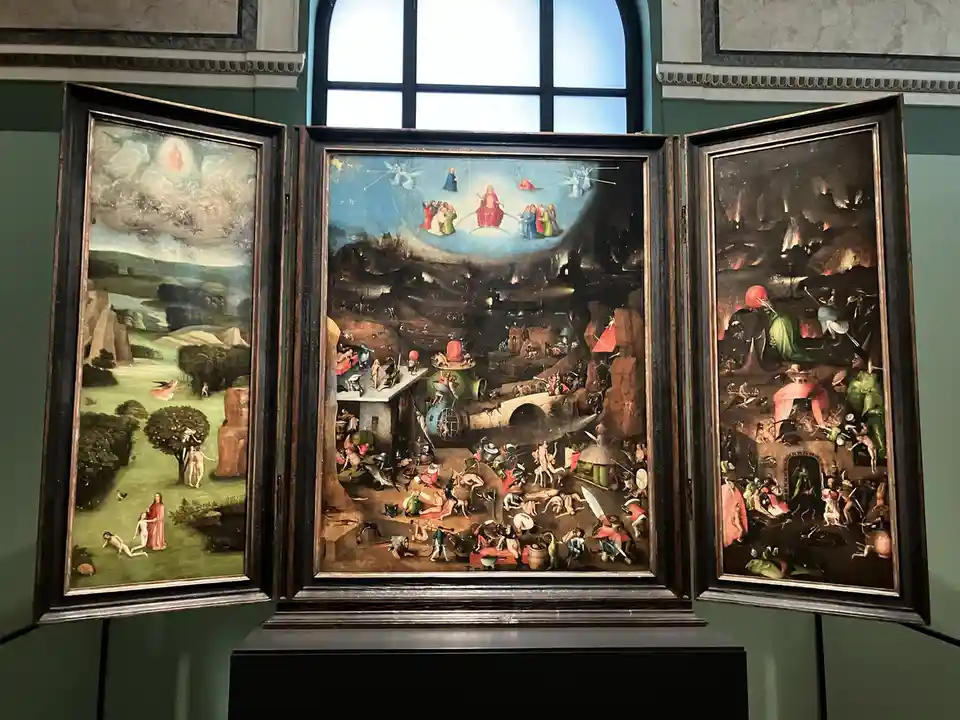 A triptych painting with three panels: left shows a serene garden, center depicts a chaotic, crowded hell with many figures…