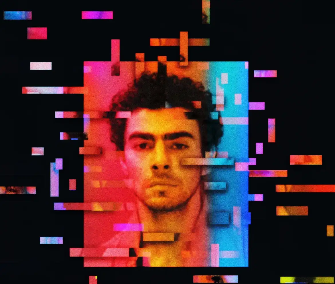 A glitch art image shows a man's face partially obscured by colorful digital static and pixelated bars, with the text 'i'm…