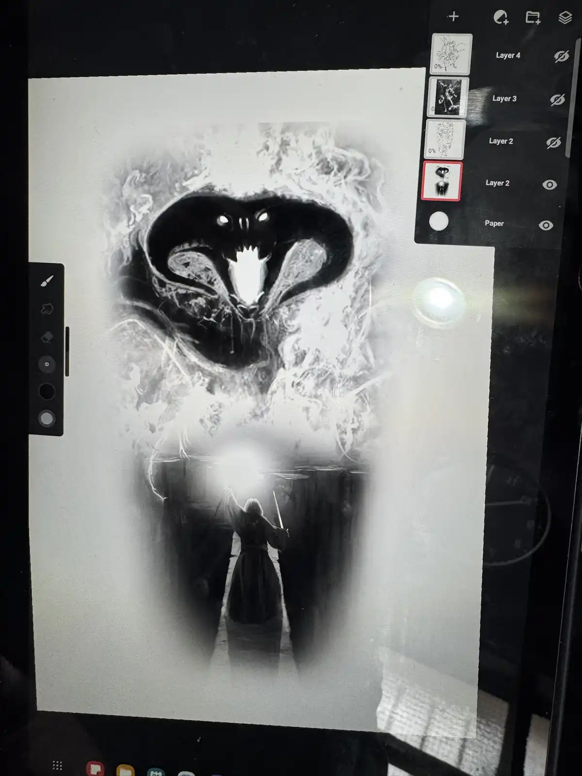 A digital art tablet screen displays a black-and-white drawing of a menacing, stylized dragon with glowing eyes and sharp…