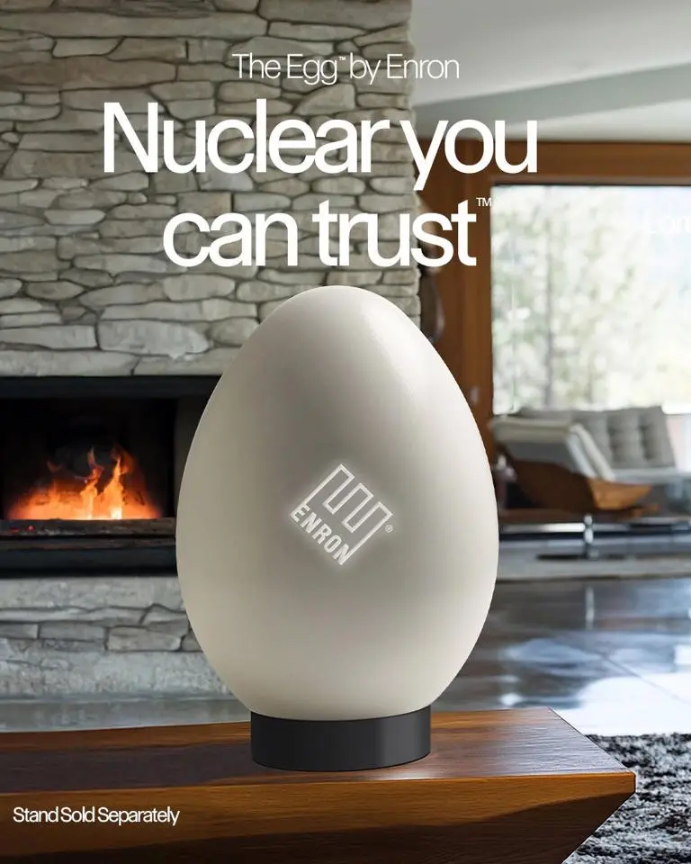 A large, beige, egg-shaped object with an Enron logo sits on a wooden table in front of a stone fireplace. The overlaid text…