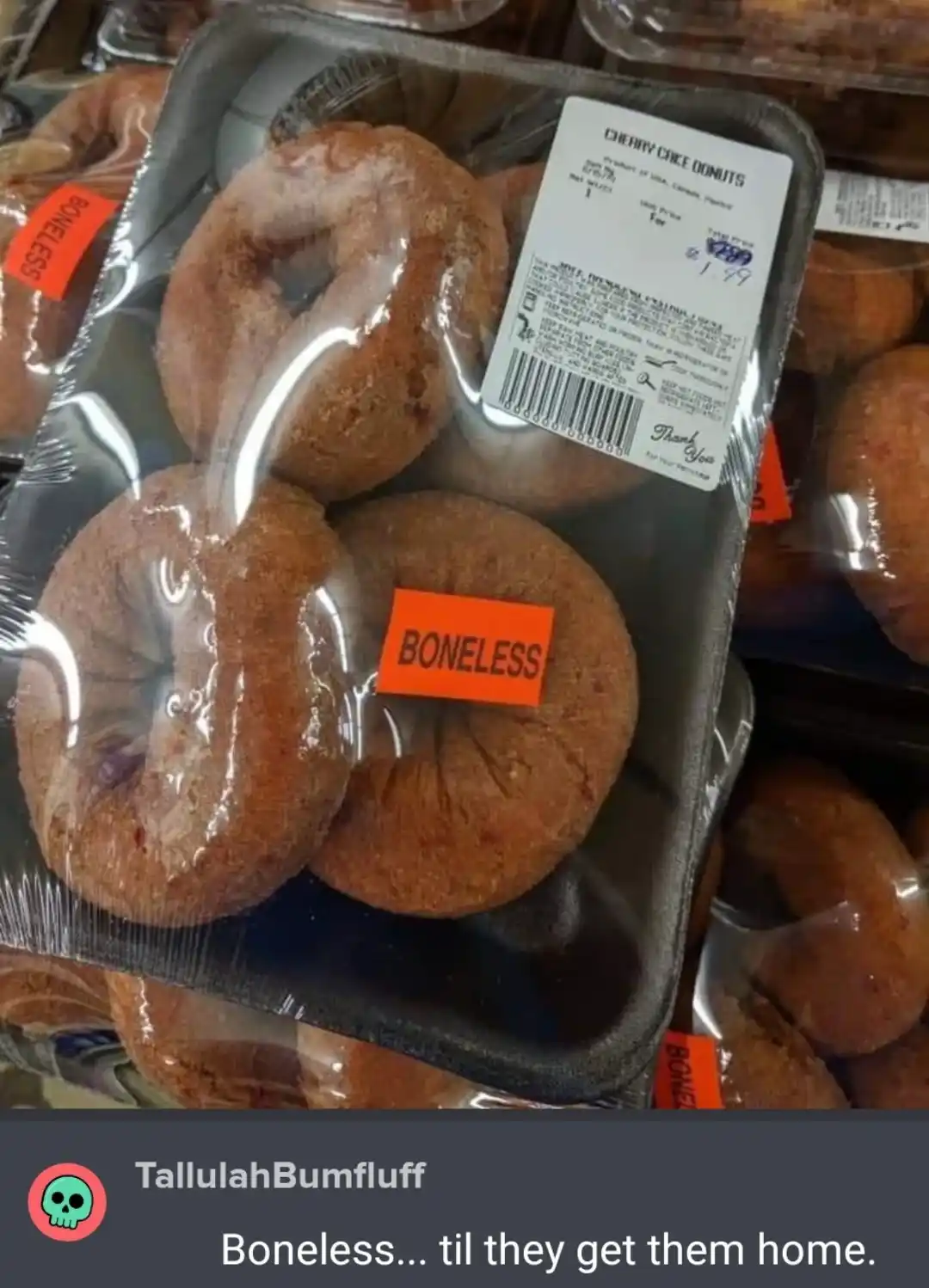 A close-up photo of a plastic tray of cherry cake donuts, each individually wrapped in clear plastic. An orange sticker on…