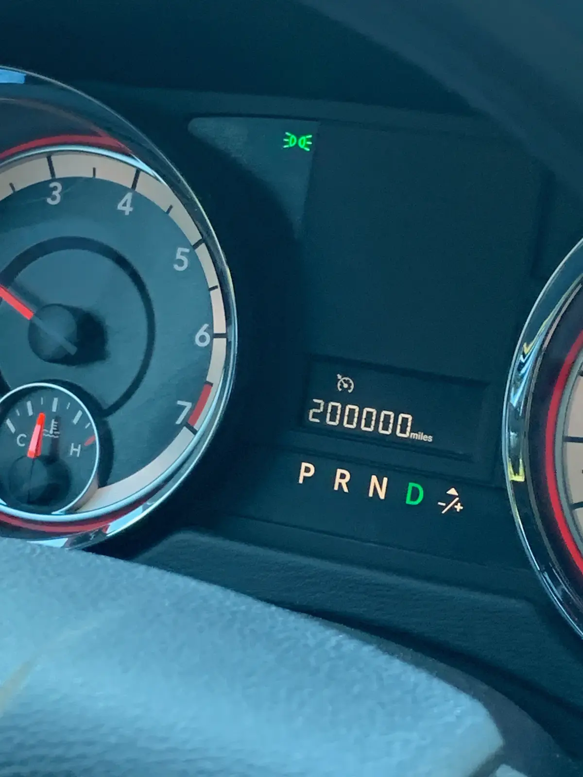 A close-up of a car's dashboard showing the odometer reading 200,000 miles, with the gear indicator lit in 'D' for drive…