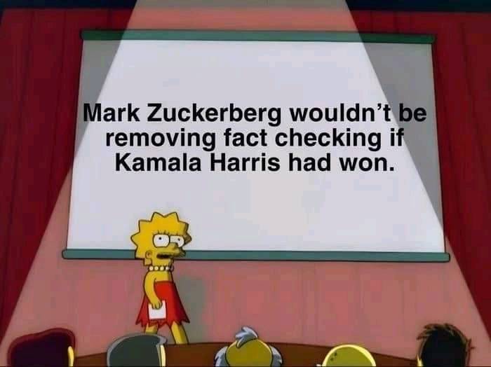 A still from The Simpsons shows Lisa Simpson standing at a podium in front of a blank projection screen, delivering a…