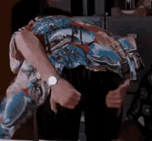 A sequence of six frames shows a person in a colorful patterned shirt and dark pants bending forward with both hands…