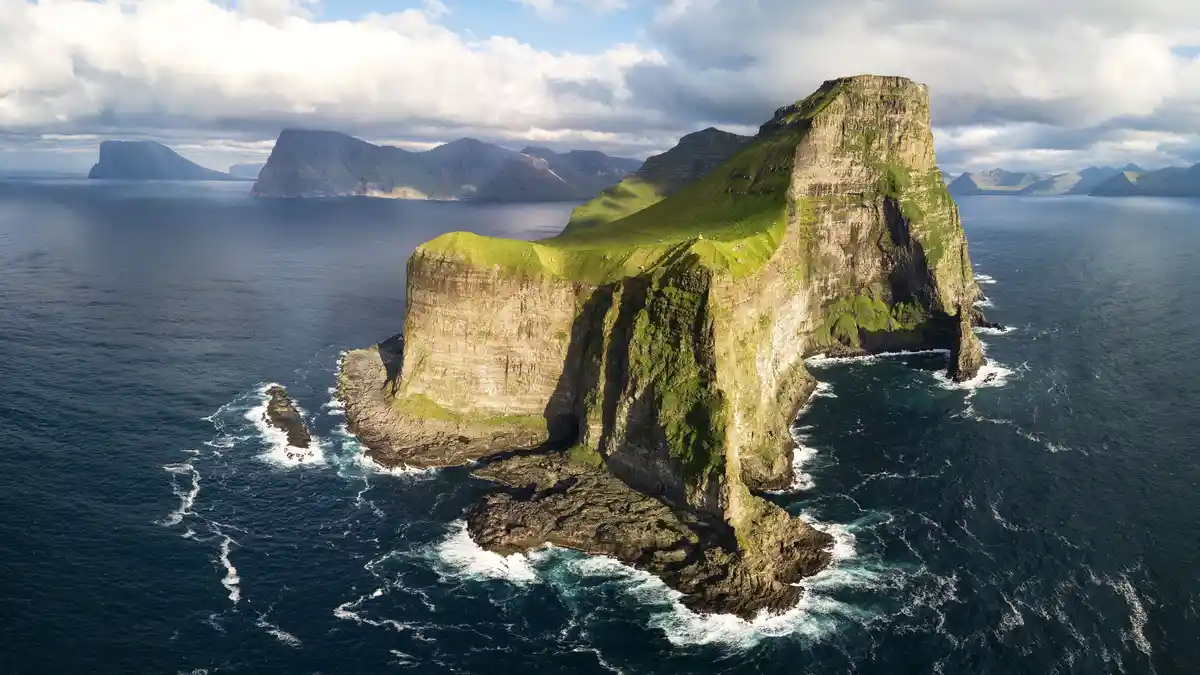 The vast North Atlantic stretches to the horizon, with a remote Faroese archipelago rising ahead. On a clear day, trekkers…