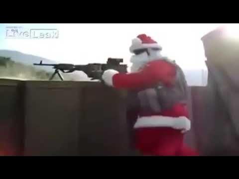 A person dressed as santa claus, wearing a red suit with white trim and a hat, is shown aiming and firing a large machine…