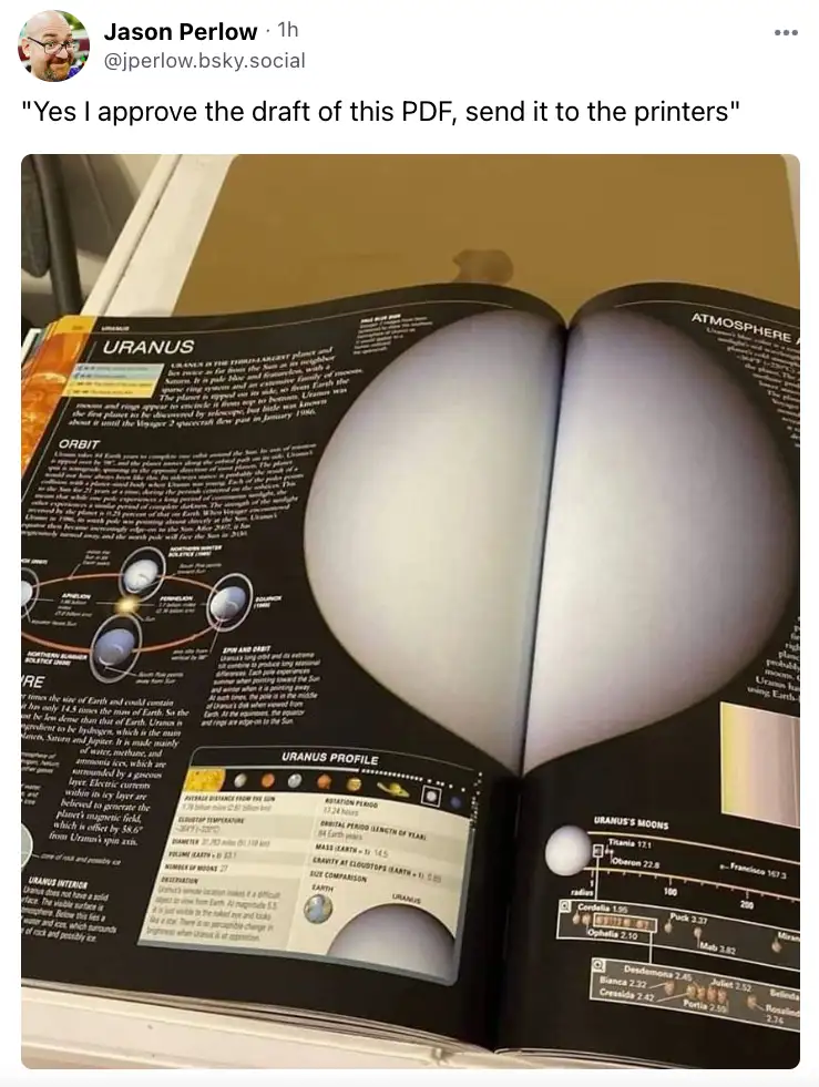 An open book displays a page about the planet Uranus, with a large, heart-shaped object obscuring the center of the page…