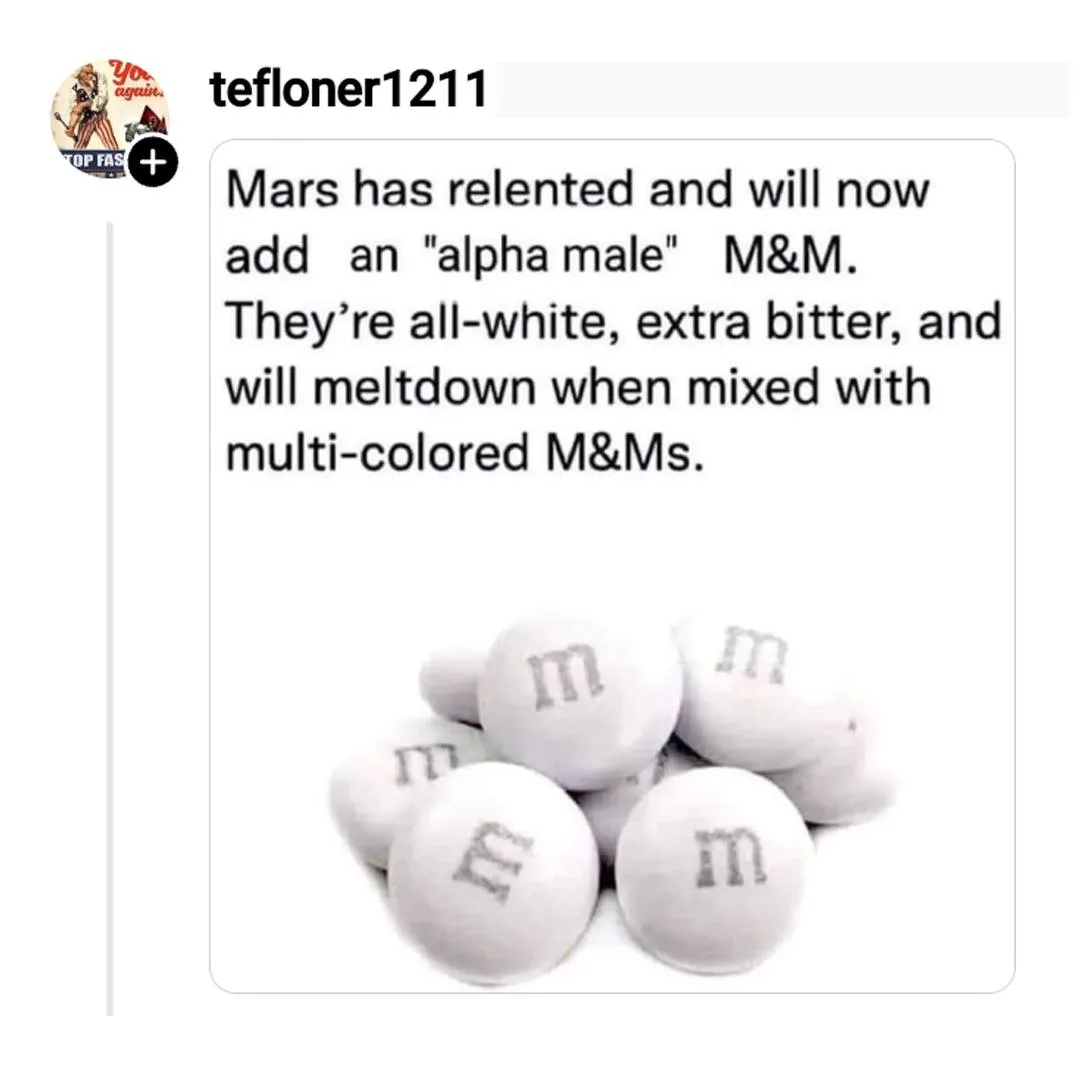 A pile of plain white M&Ms with the letter 'm' printed on them, overlaid with text claiming Mars is adding an 'alpha male'…