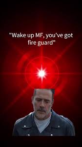 A man with a mustache and dark jacket stares forward against a dark red background with a bright red glowing starburst…
