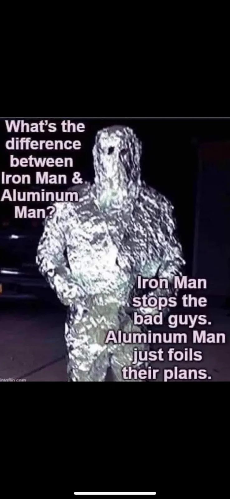 A person is fully wrapped in crinkled aluminum foil, standing in a dark outdoor setting. Overlaid text poses a joke…