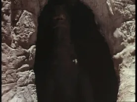 A six-panel sequence shows a large, reptilian monster emerging from a dark cave entrance, progressively revealing more of…