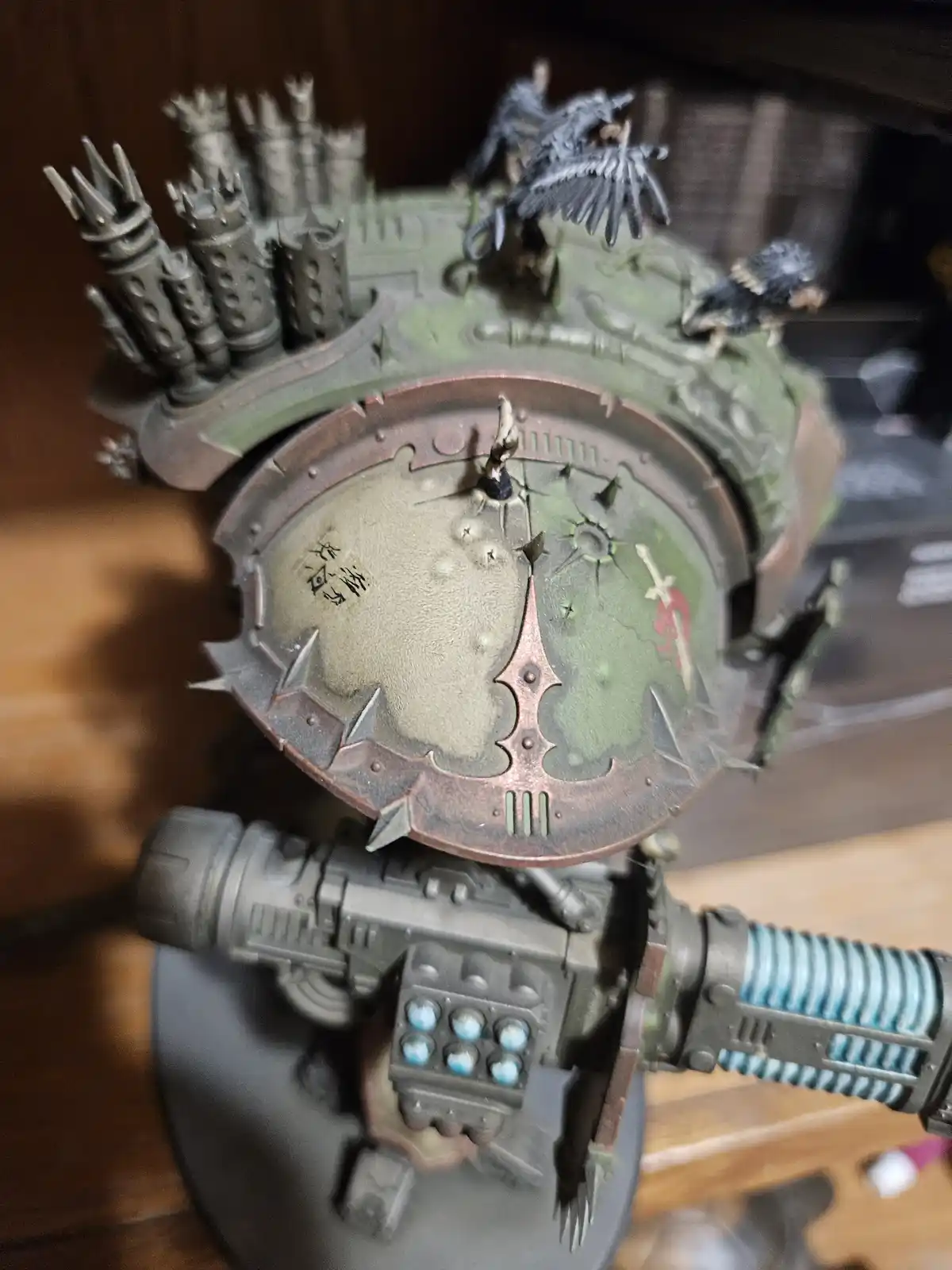 A close-up of a heavily detailed, painted Warhammer 40k miniature, likely a Space Marine or similar armored figure, showing…