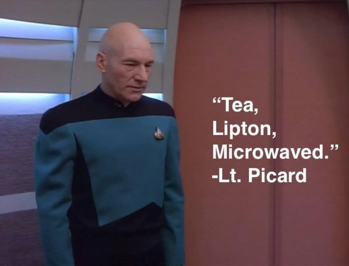A still image of Captain Jean-Luc Picard from Star Trek: The Next Generation, wearing his blue command uniform and looking…