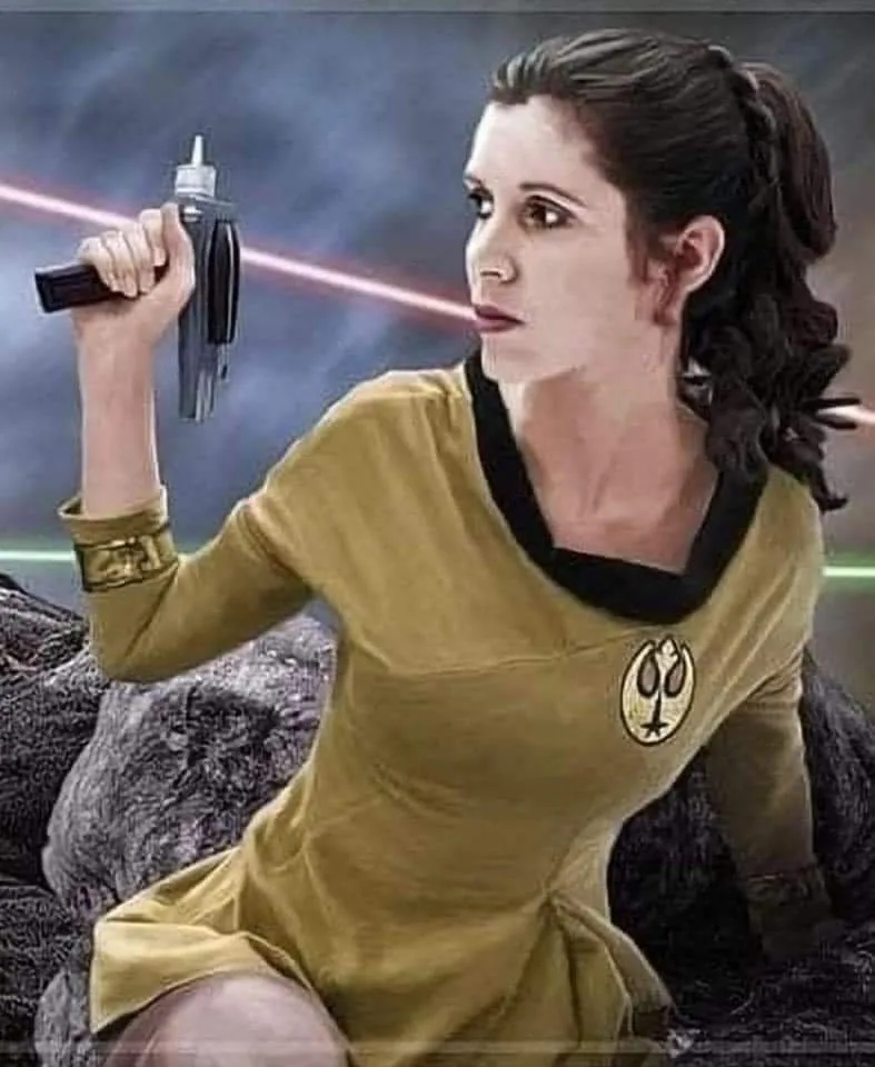 A woman in a yellow Starfleet uniform with a Star Trek insignia on her chest holds a lightsaber, looking serious as red…