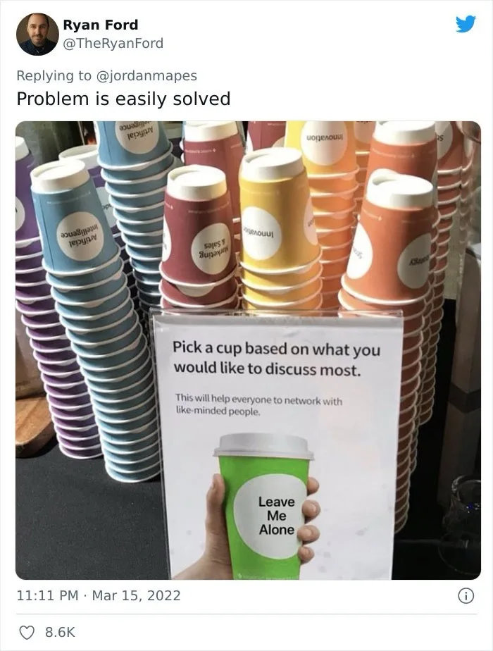 A photo shows stacks of colorful paper coffee cups, each labeled with business topics like 'Artificial Intelligence' or…