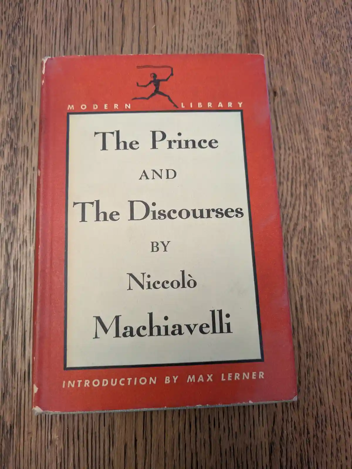A red hardcover book titled 'The Prince and The Discourses' by Niccolò Machiavelli, part of the Modern Library series with…